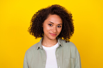 Photo of nice wavy young brunette lady wear grey shirt isolated on yellow color background