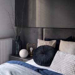 Dark and elegant bedroom corner, close-up