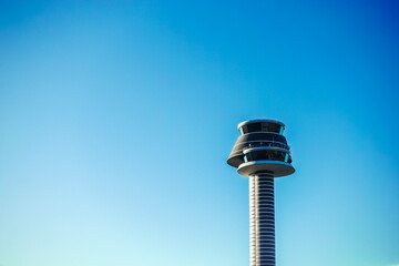 Modern high tech air traffic control tower of Arlanda airport in Sweden with blue sky background copy space as travel, tourism and transport concept