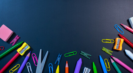 blackboard with pencils, crayons, pencil sharpener, rubber