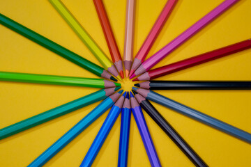 colored pencils on yellow background