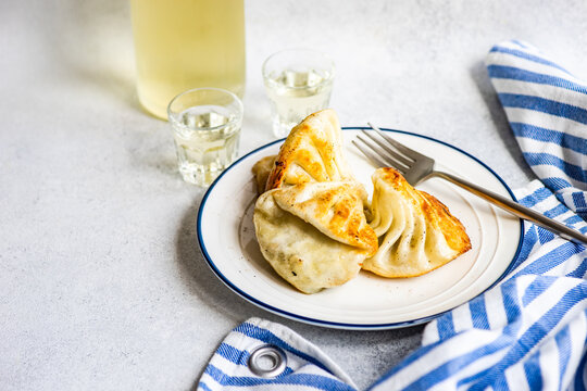Close-Up of a plate of fried Georgian khinkali and two glass of traditional Georgian chacha