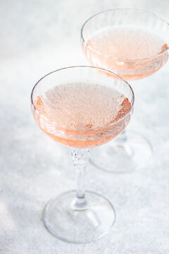 Close-Up of two glasses of pink champagne in champagne coupe glasses
