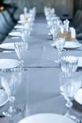 Catering table set service with silverware, napkin and glass at restaurant before party