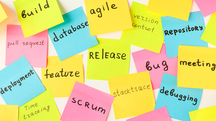 Multi-colored square stickers with terms from the IT field - release, bug, meeting, feature,...