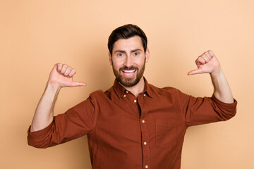 Photo of cheerful nice person indicate thumb fingers himself isolated on beige color background