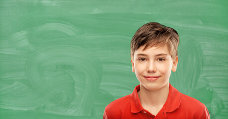 education, school and people concept - portrait of happy smiling student boy in red polo t-shirt...