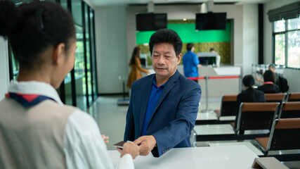 business man at check-in counter with airlines staff. Airline transportation and tourism concept.