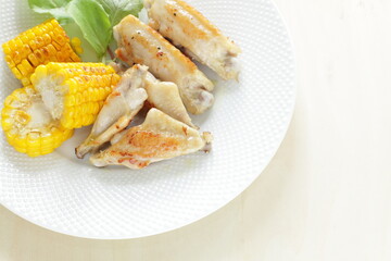 Barbecue chicken wing and sweet corn seed with salad for summer outdoor food image