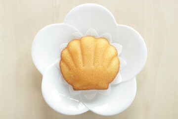 French sweet food, shell shape cake on white dish