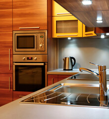 Modern wooden kitchen unit with built-in appliances