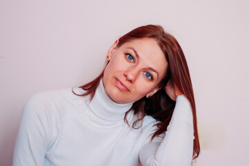 Obraz premium Portrait of a blue-eyed woman. Girl with red hair.