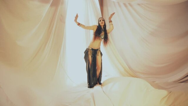Sensual woman dancing in thin fabrics