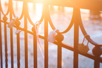 Heart-shaped locks hang on the fence on the river embankment as a sign of love and loyalty for a...