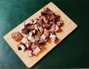 Smoked Pork pieces placed in a chopping board. 