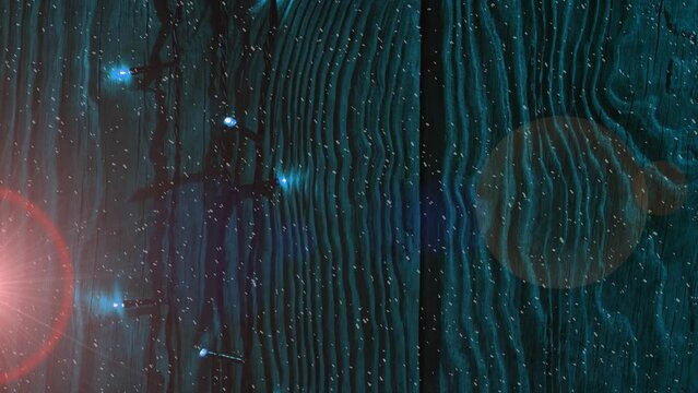 Animation of bokeh effect and abstract pattern against illuminated wooden fence