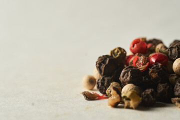 Details of a mountain of colored pepper on a white background
