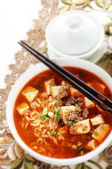Fusion food, Chinese mapo tofu and ramen noodles in white bowl
