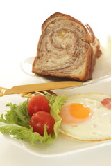 Fototapeta na wymiar Bacon and sunny side up fried egg for homemade breakfast image
