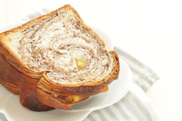 Sliced chestnut and chocolate bread on white plate for breakfast 