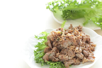 Korean food, stir fried beef with sesame seed served with lettuce