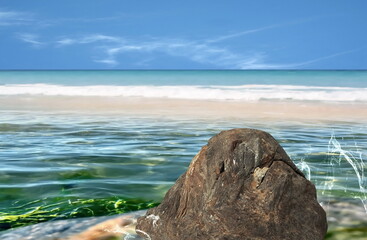 emerald green sea water  and splash big stone rock palm tree leaves , white sand beach and blue sky tropical  nature landscape defocus  background