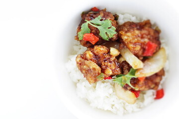 Chinese food, sour and sweet chicken on ricewith coriander leaves 