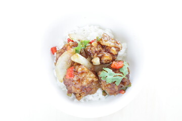 Chinese food, sour and sweet chicken on ricewith coriander leaves 