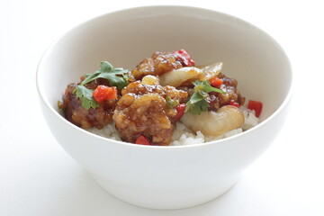Chinese food, sour and sweet chicken on ricewith coriander leaves 
