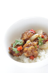 Chinese food, sour and sweet chicken on ricewith coriander leaves 