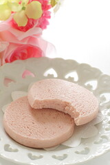 Pink color strawberry cookie on white dish for confectionery image