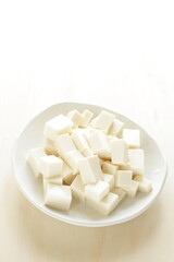 chopped Tofu on white dish with copy space for cooking ingredient 