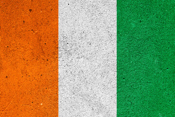 State flag of the Republic of Cote dIvoire on a plaster wall