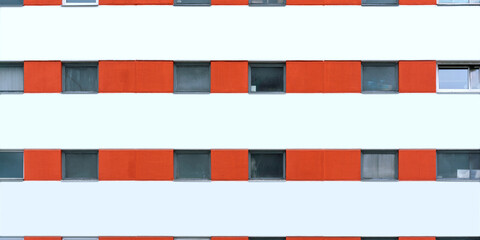 corporate city building wall of orange and white colours with small windows and mockup place © Bonsales