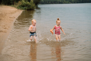 children play in the water with dirty hands in the lake located in the Lipetsk region