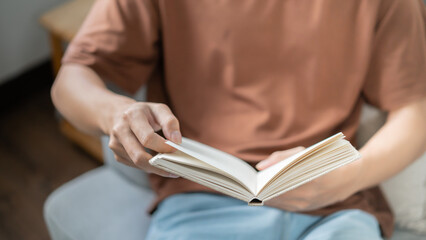 Men reading book and relaxing at home and comfort in front of opened book