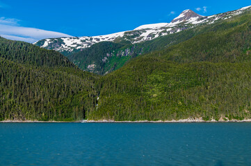 A view of wooded sides of the Chilkoot Inlet close to Skagway, Alaska on a summers evening