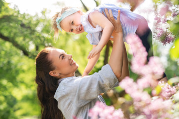 family, motherhood and people concept - happy mother with little daughter at summer park or garden