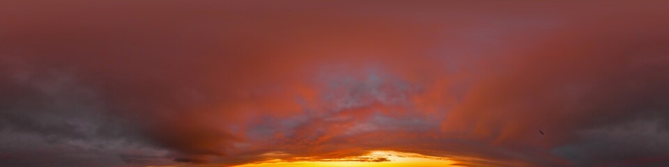 Burning red dramatic overcast dark sunset sky panorama. Hdr seamless spherical equirectangular 360 panorama. Sky dome or zenith for 3D visualization and sky replacement for aerial drone 360 panoramas.
