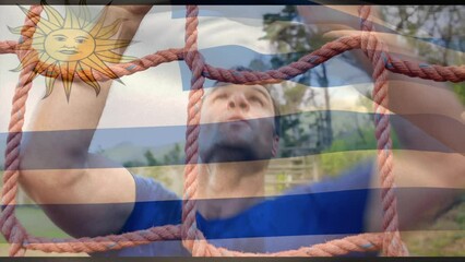 Animation of flag of argentina over caucasian man during obstacle race training - Powered by Adobe