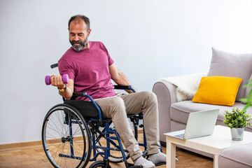 Disabled man sitting in wheelchair and exercising with dumbbells at home. Rehabilitation of disabled people. Mature man in wheelchair working out at home. Disabled Man Lifting Dumbbells at home
