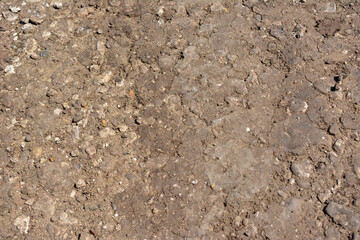 dirty country road with gravel isolated, close-up