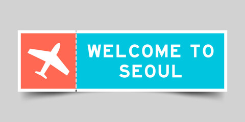 Orange and blue color ticket with plane icon and word welcome to seoul on gray background