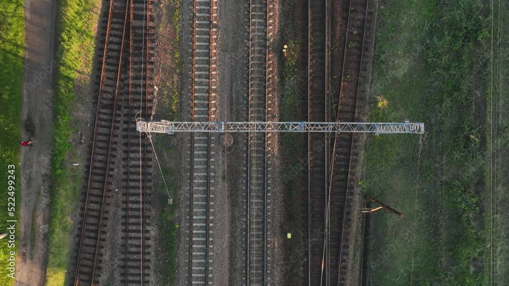 Poster the view from the drone on the railroad tracks against the background of the setting sun. concept of