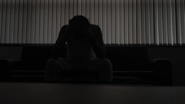 stressed man in a dark room