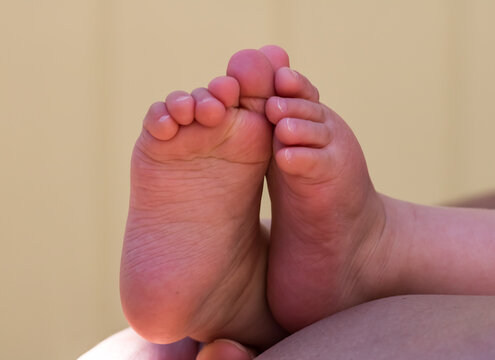 Close up of the bottoms of adorable baby's feet.