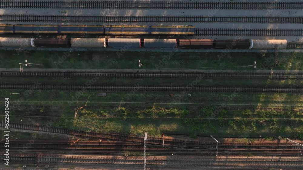 Poster the view from the drone on the railroad tracks against the background of the setting sun. concept of