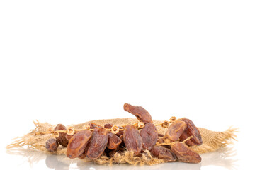 One branch with dry sweet dates with jute fabric, close-up, isolated on white background.