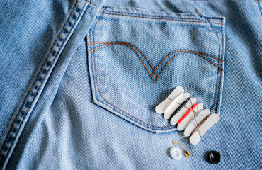 Hotel sewing kit on jeans. Small portable thread repair emergency kit with needles, buttons,...