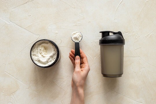 Hands making shake with whey protein. Fitness and gym diet nutrition